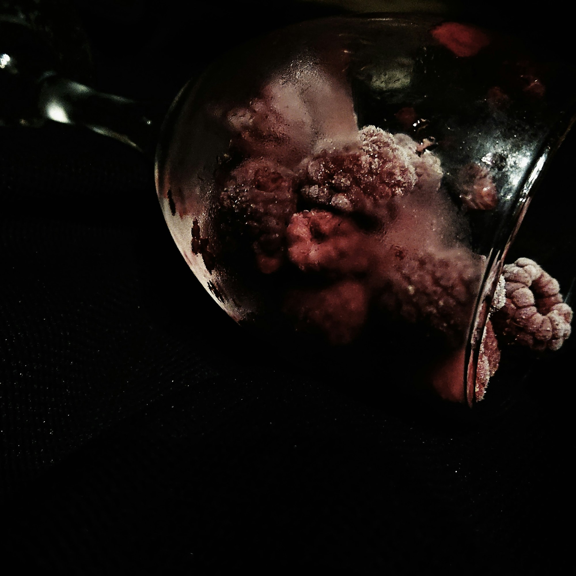 Frozen raspberries in an iced glass